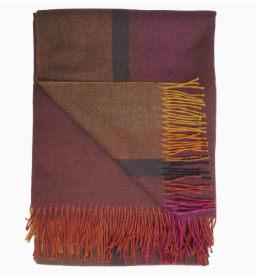 Plaid blanket with fringed edges in shades of purple, brown, and orange on a white background